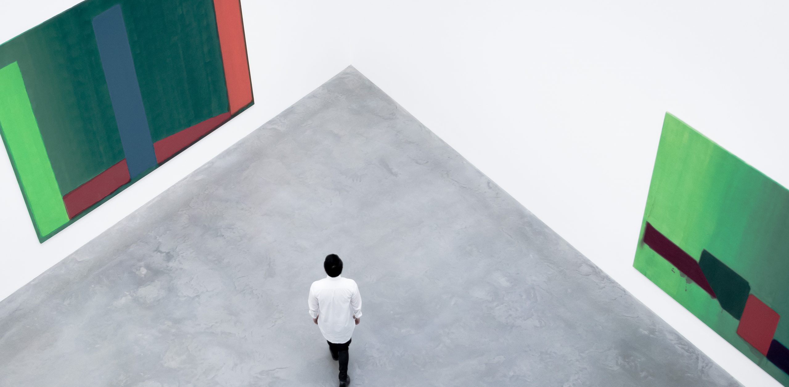 a man walking in an art gallery