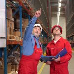 A SEMA approved inspector pointing to warehouse racking