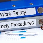 workplace safety and safety procedures folders on a desk
