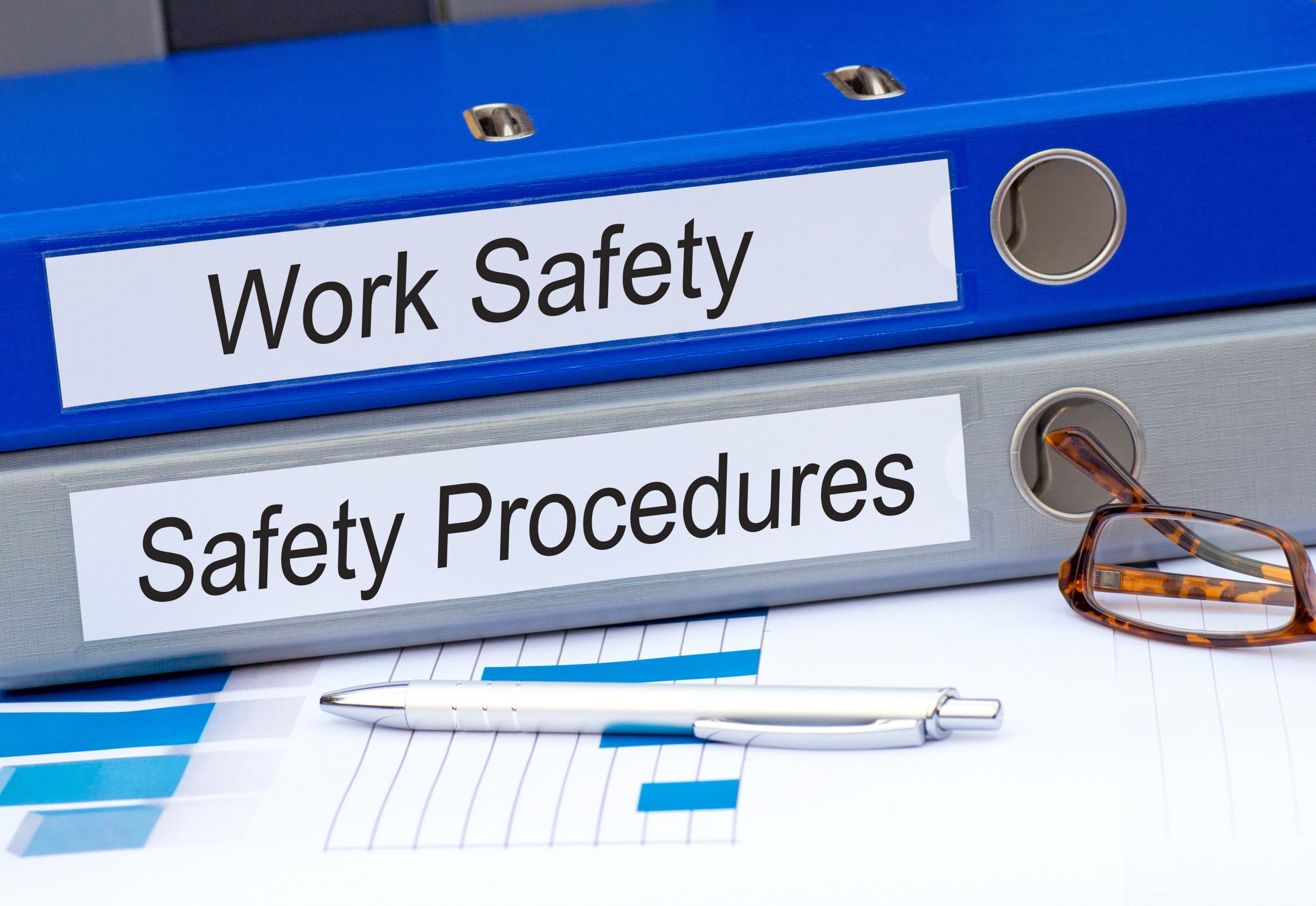workplace safety and safety procedures folders on a desk